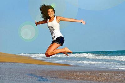Smiling girl jumping by the sea - Image by Gerd Altmann from Pixabay