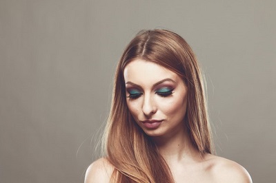 Photo of woman form shoulders up with makeup