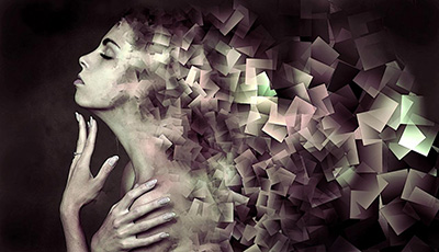 Stylised side profile of a woman's face fading into cubes