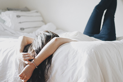 Person relaxing on a bed