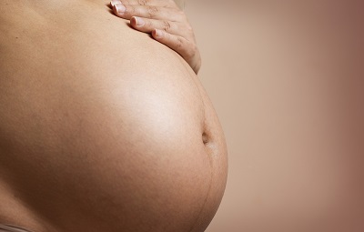 Pregnant woman with her hand on her belly